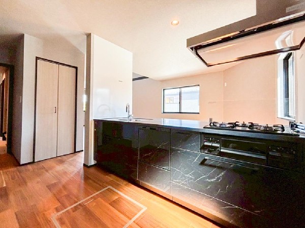 リビングに降り注ぐ明るい陽射しがそのままキッチンにも柔らかく降り注ぐ明るい印象のキッチン廻り。リビングとキッチンの間に壁を設けてないフルオープンタイプですので、空間に一体感を感じられます。