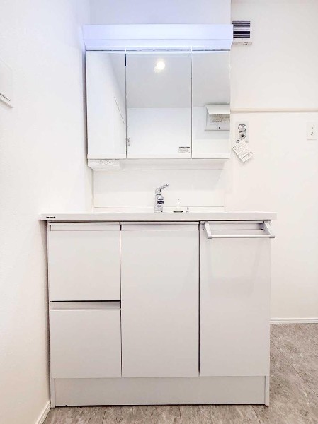 シンプルで清潔感のある洗面化粧台。収納を確保し、家族みんなが快適に使える設計です。