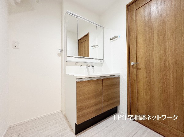 鏡の裏に収納棚を確保した三面鏡を採用。化粧品や歯ブラシなどを機能的に収納。また、三面鏡の本当の利点は三枚の鏡を合わせることで、頭の側面や背面が見れること。