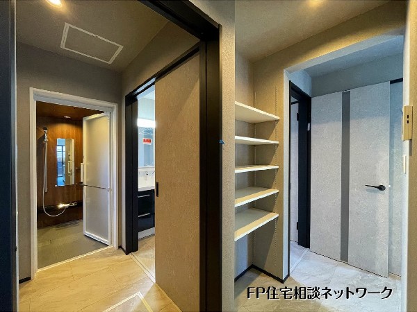 【パントリー】  家事効率を高める絶妙な動線。廊下には可動棚付きパントリーを設け、収納力を確保しました。広々とした脱衣室は使い勝手抜群。毎日の「洗う・しまう」をスムーズにする、機能的な水回り設計です。