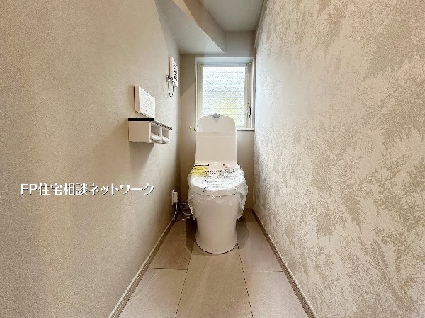 窓付きで明るく換気もしやすいトイレ空間。温水洗浄便座を採用し、アクセントクロスが上品な印象を演出します。毎日使う場所だからこそ、快適さに配慮した設計です。