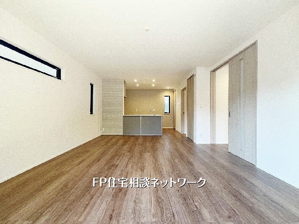 【LDK│17帖】  白壁と木目調の床が調和した明るいリビングです。キッチンから室内を見渡せる開放的な設計で、家族の時間を大切にできます。シンプルな空間は、自分好みの家具やインテリアで自由にアレンジが可能で