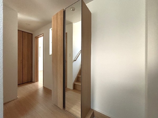 玄関収納は、天井まであるタイプのため、家族全員のレインブーツなど、たっぷりと収納できます。大きな扉一枚サイズの鏡付で、お出かけ前の身だしなみチェックにも便利です。